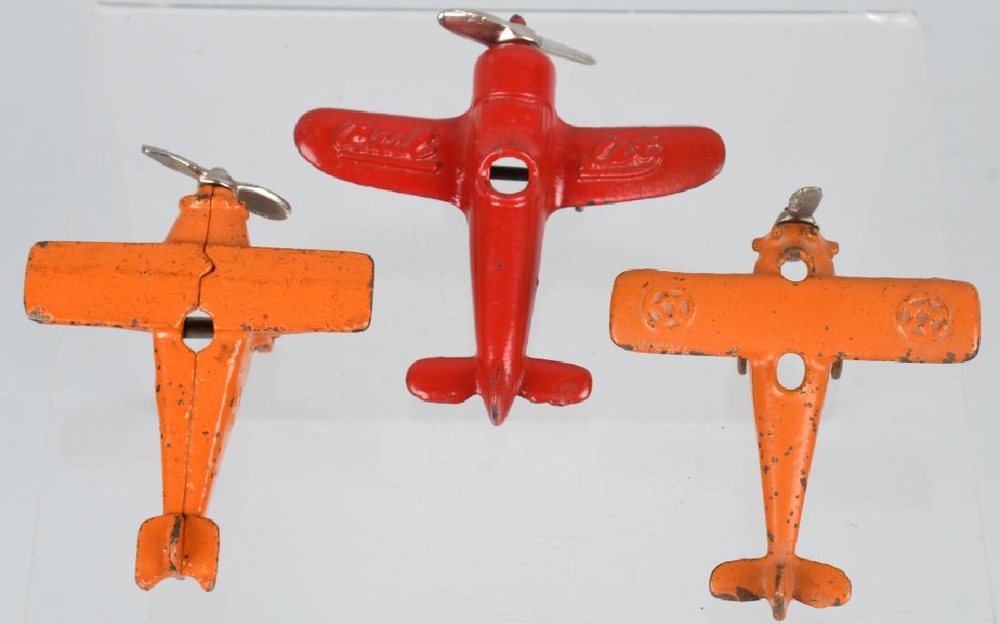 3 KILGORE cast iron AIRPLANES: Lot includes 3 different Kilgore cast iron airplanes. Wing span on largest is is 3 7/8" by 4". The 2 orange planes are all original the red Bullet plane is repainted with replacement prop. Very Good-E