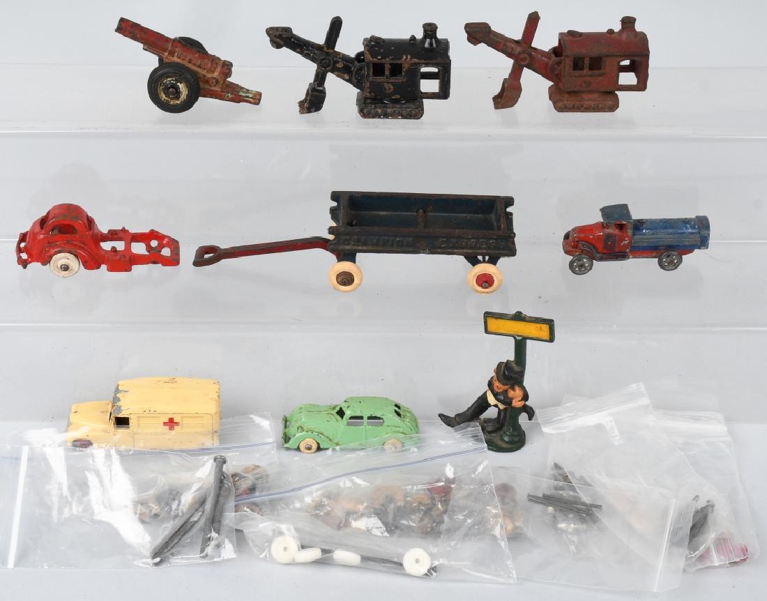 VINTAGE TOY LOT, cast iron, die cast, & PARTS: Lot includes 2 cast iron 4 1/2" steam shovels, an Arcade cannon, a Champion wagon *' including handle, a Hubley Cab over part, a Dinky ambulance,a Hubely die cast car, a die cast Barclay Mack tanker, 