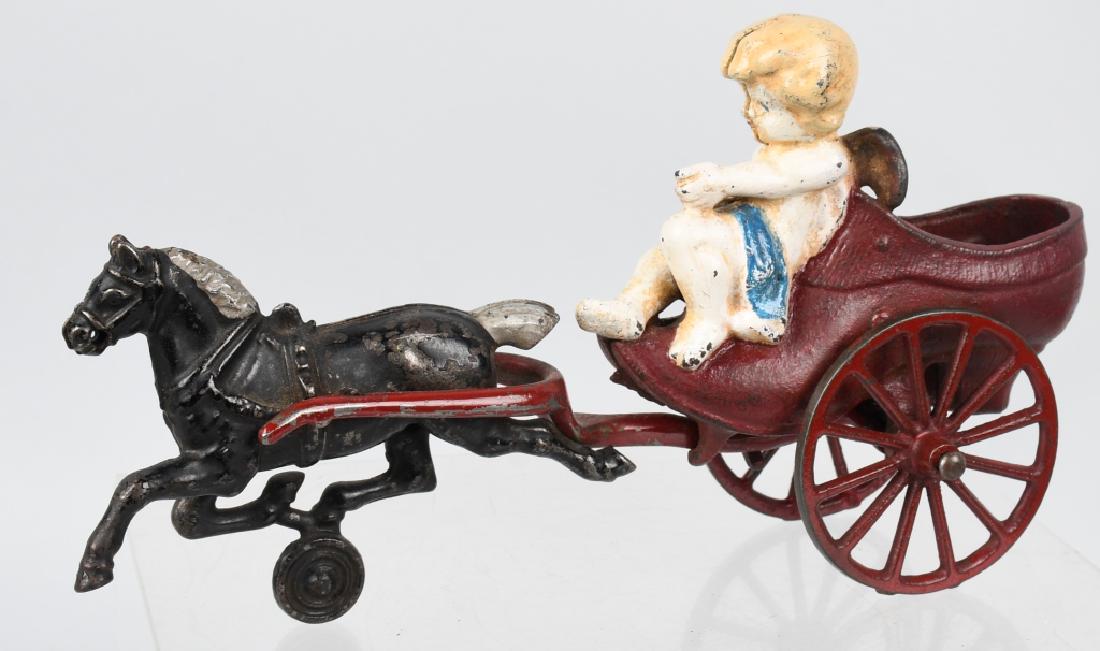 KENTON cast iron HORSE DRAWN CUPID SLIPPER: Very hard to find Kenton cast iron toy dating from the 1890's. Has paint touch up, but no cracks or breaks. 8 3/4", Very Good