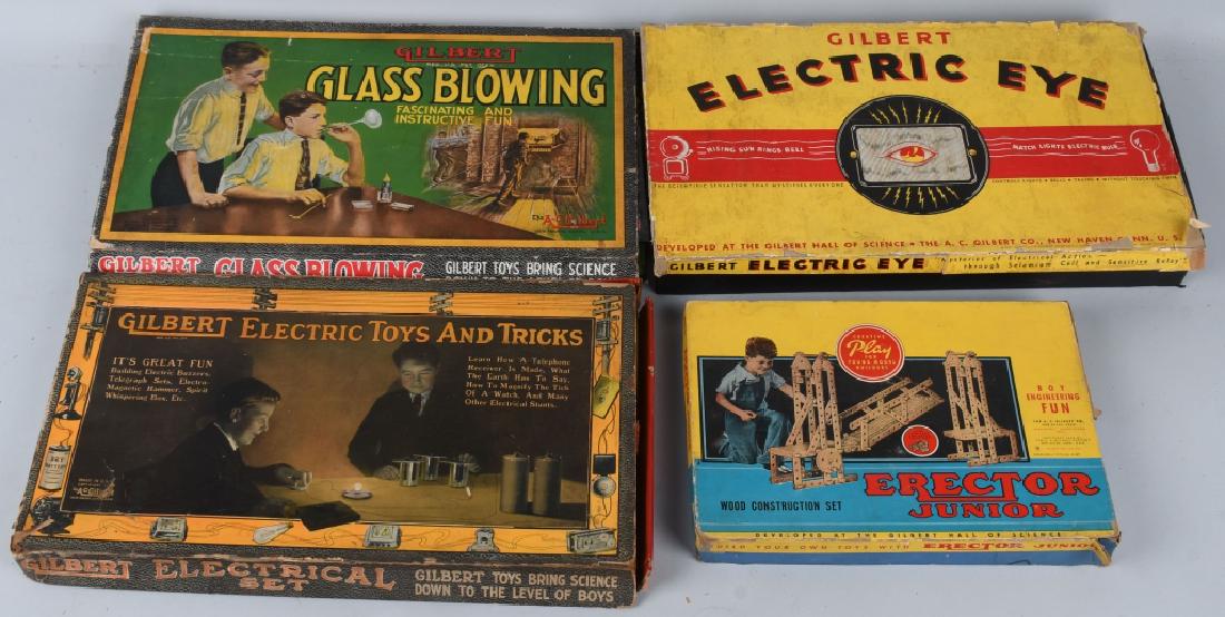 4 VINTAGE GILBERT SETS ERCETOR GLASS BLOWING MORE: Lot includes a 1943 wood Erector set made during WWII, a 1920 Glass Blowing set, one piece broken, an Early Electric Toys and Tricks set, and a 1935 Electric Eye set. Appear mostly complete. Largest i