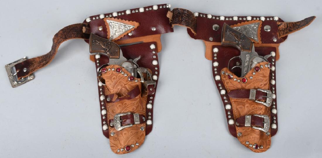 PAIR of ROY ROGER CAP GUNS & LEATHER HOLSTER: Nice Roy Roger Holster Set. Both Cap Gun are original and work. Both with nice finish. Comes with fancy leather Holster. Guns measure 9 1/2" Excellent