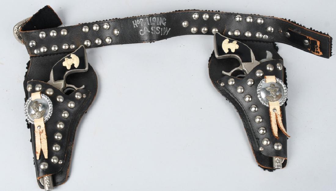 HOPALONG CASSIDY CAP GUNS & LEATHER HOLSTER: Pair of Hopalong Cassidy Cap Gun all original and work. Comes with Hopalong Cassidy leather Holder. 10" Excellent