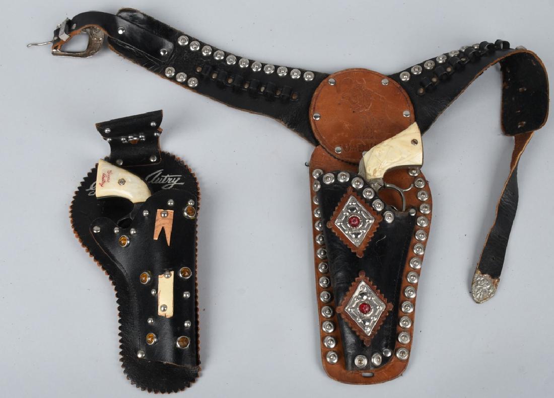 BILL HICKOK & GENE AUTRY CAP GUNS w/ HOLSTERS: Includes Wild Bill Hickok and Gene Autry Cap Guns. Both original and working. Both with leather Holsters. Largest 10" Excellent