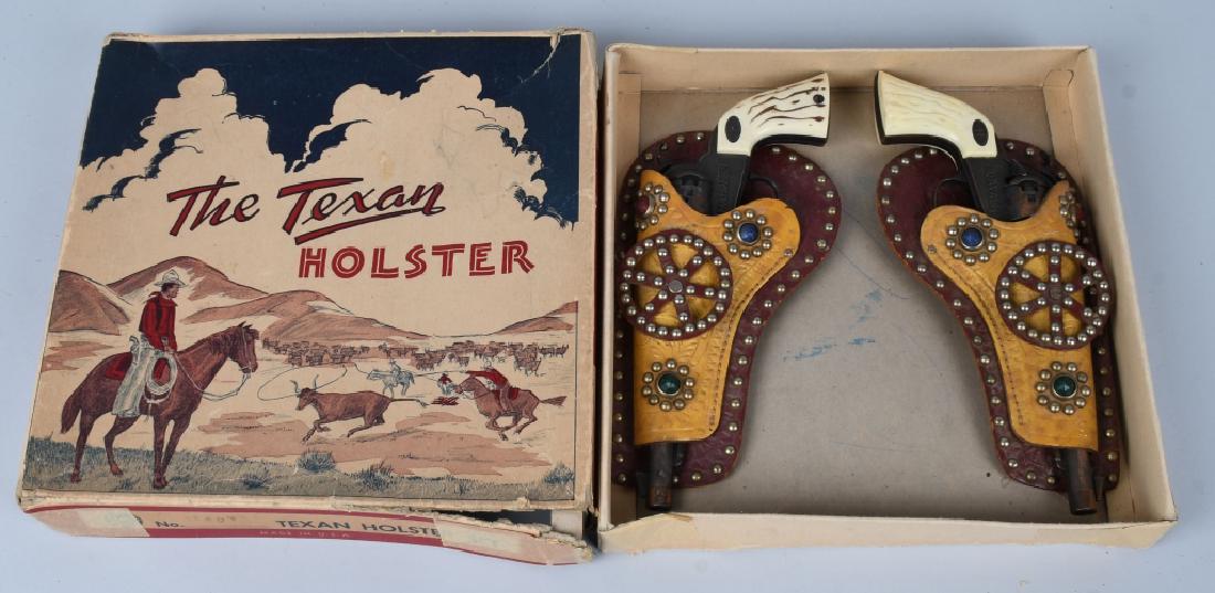 THE TEXAN HOLSTER: Pair of Texas Ranger Cap Guns original and work with leather Holsters. Comes with The Texan Holster Box. 12" Excellent
