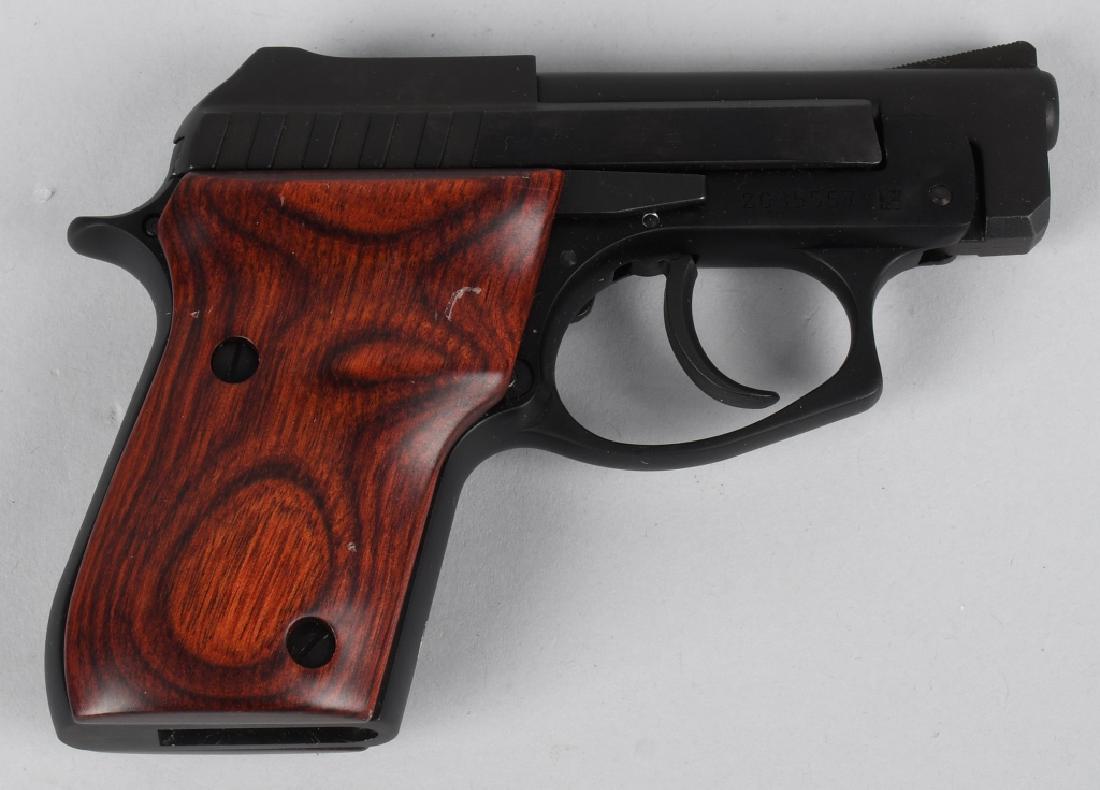 TAURUS PT 22 COMPACT PISTOL 22 CALIBER: SN Z035557. 2.75" barrel semi automatic tip up pistol in .22 LR. Taurus PT-22. Features fixed sights, steel frame, and serrated slide. Blued finish. Rosewood grips. Bore near mint, functions flawlessl