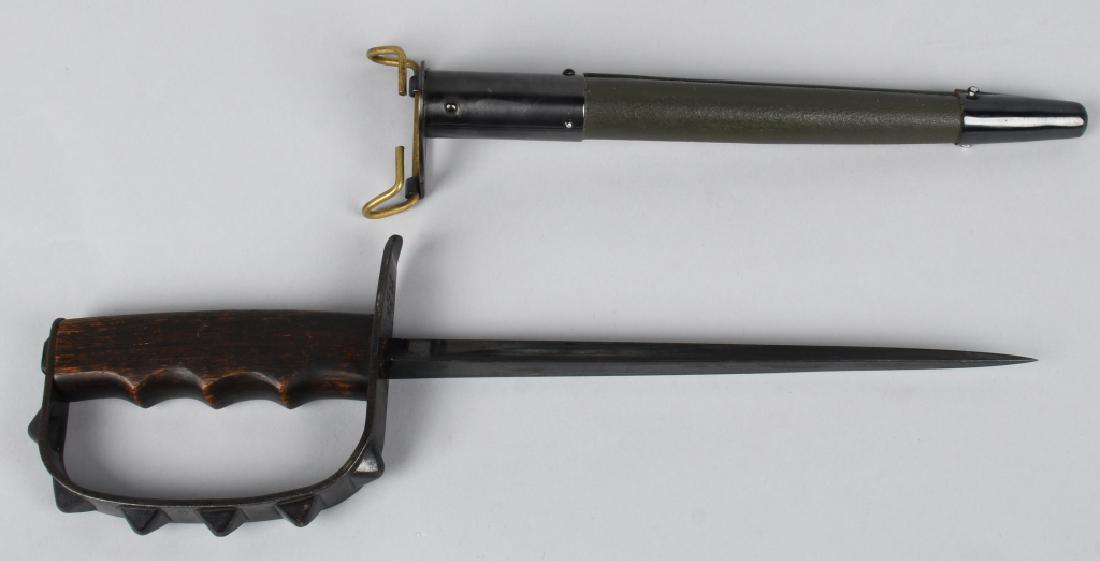 WWI US MODEL 1917 TRENCH KNIFE KNUCKLEDUSTER: LF&C Model 1917 trench knife with triangular blued blade, wooden handle, and "pyramid" style knuckle duster guard. Comes with "Jewel 1918" marked reproduction scabbard. Knife itself is near mint - sca