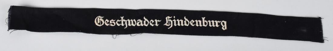 WWII LUFTWAFFE GESCHWADER HINDENBURG CUFFTITLE: Deep navy blue wool construction cufftitle with Gothic embroidered script in silvery thread approximately 18" (46cm) in length, unworn example, in near mint condition. Kampfgeschwader 1 (KG 1) (Battle