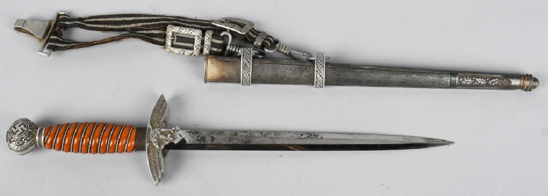 WWII NAZI SMF LUFTWAFFE DRESS DAGGER W/ HANGERS: Roughly 29cm long bright nickel/silver plated double edged drop forged steel stiletto style blade with a flat central plane. Maker marked to "SMF" with seated king logo and issue Waffenamt. The leathe