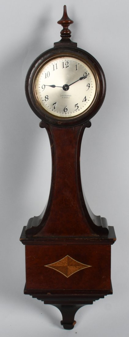 SETH THOMAS BANJO STYLE CLOCK: Nice vintage Seth Thomas Banjo Clock. All original with nice wood case. There is a nice wood inlay on the case. Clock has been serviced and works. 20" Excellent