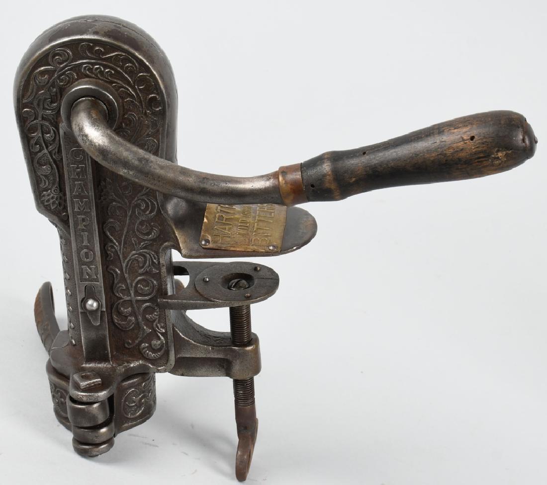 CHAMPION CAST IRON WINE OPENER w/ ADVERTISING: Very ornate cast iron Champion Wine Bottle Opener. All original and working. Has unusual brass advertising plaque for Harter's Wild Cherry Bitters. A wonderful early piece. 9" Excellent