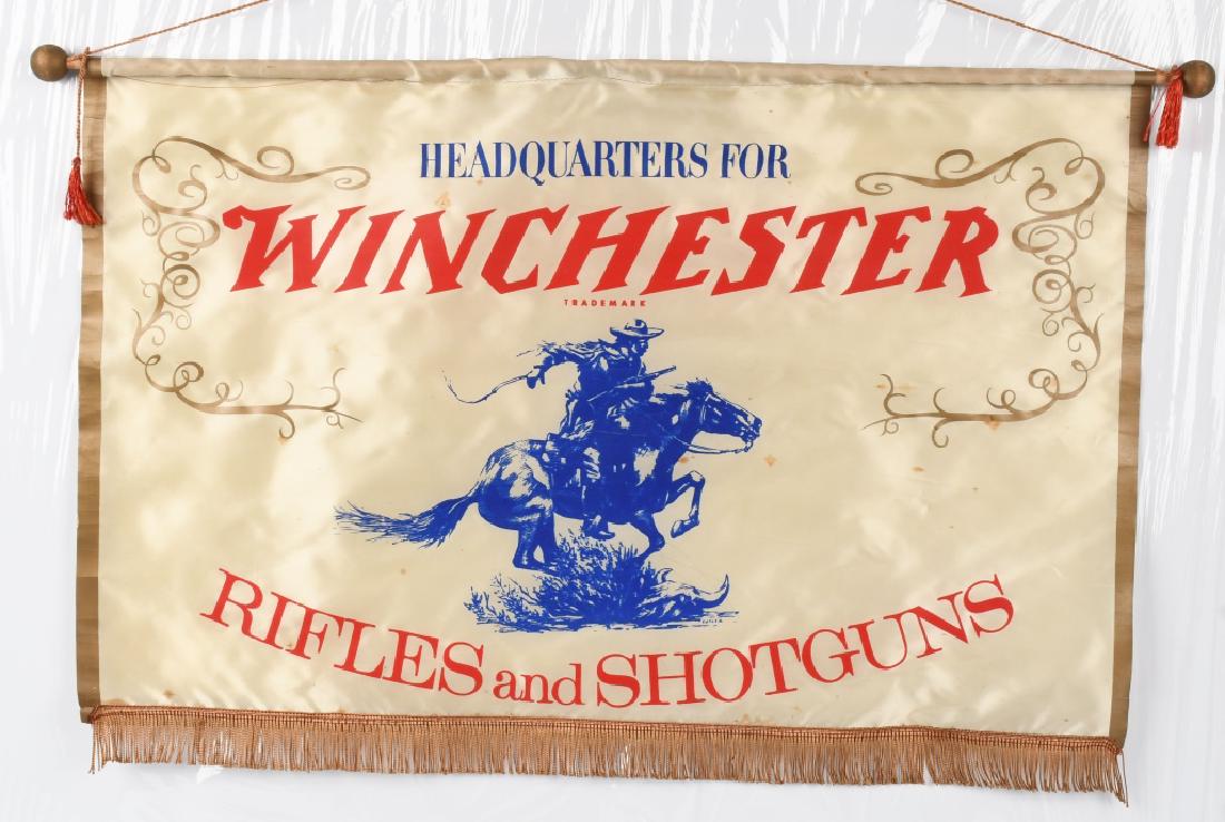 VINTAGE ORIGINAL WINCHESTER RIFLES DEALER BANNER: Measures approximately 28" x 20" - silk material with gold fringe suspended from wooden dowel rod. Reads "HEADQUARTERS" "WINCHESTER RIFLES AND SHOTGUNS" and features Winchester logo. Tassels appear to
