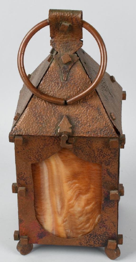 ARTS & CRAFTS COPPER SLAG GLASS LANTERN: Wonderful example of Arts and Crafts period metal work. Each side has an amber swirl slag glass panel. Top is hinged for lighting. 19" by 6 1/4" by 6 1/4". Excellent