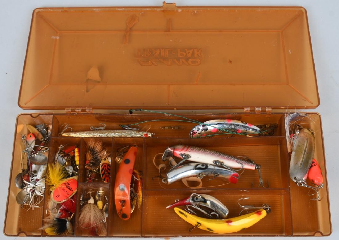 OVER 15 VINTAGE FISHING LURES MEPPS, HEDDON: 15+ vintage fishing lures in a Plano Trail-Pak case. Mostly wood and metal construction, jointed, one in the original box, ranging in size from approximately 2" to 7." Excellent.