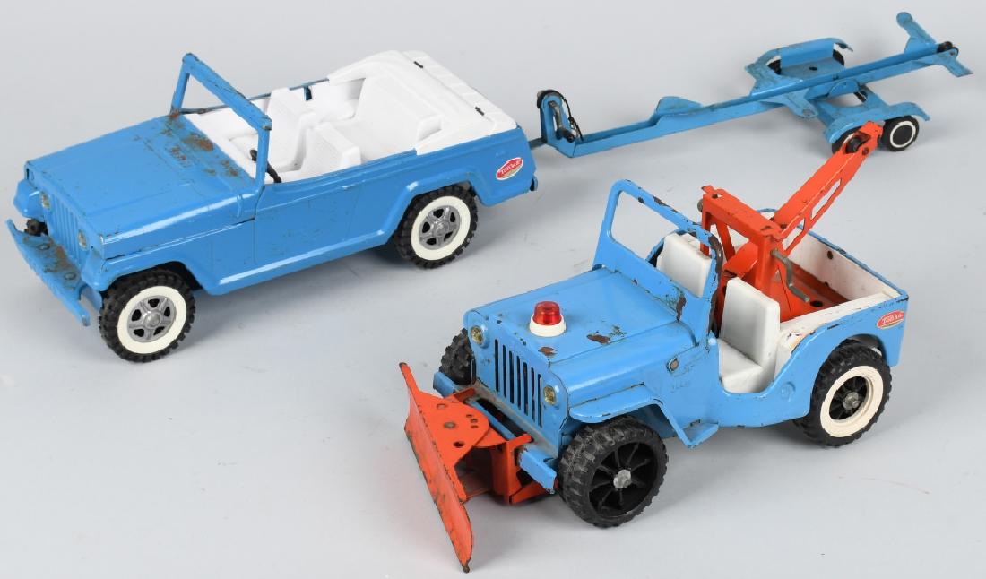 2 - TONKA JEEPS, WILLYS and WRECKER: Lot includes a pressed steel Jeep wrecker with plow blade along with a Jeepster with boat trailer. Wrecker is missing a white wall and hub cap. Both are all original with some areas of rust. Largest i