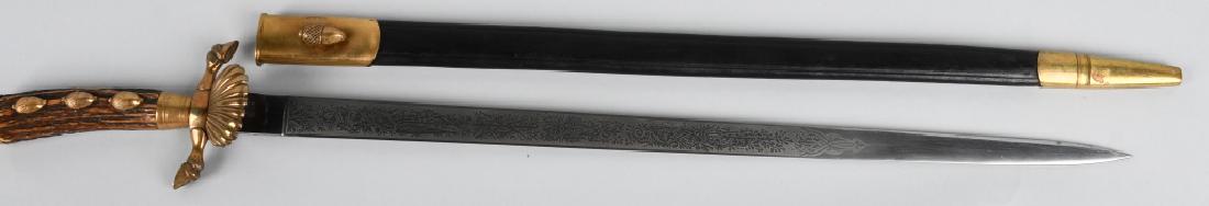 WW1 ERA IMPERIAL GERMAN HUNTING CUTLASS: WWI Era Imperial German Hunting Cutlass made by WKC. Cutlass has a double etched blade and a stag handle with 3 acorns with a fluted clamshell. Blade, handle, and scabbard are all marked with the numb