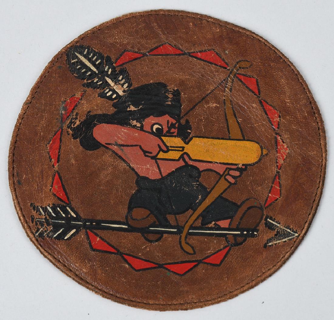 WWII US AIR CORPS 77TH BOMB GROUP SQUADRON PATCH: WWII US Army Air Corps 77th Bomb Group patch in leather has been removed from the flight jacket measuring 4 1/2 inches. This Walt Disney designed patch depicts a little Indian boy with feather in hatb