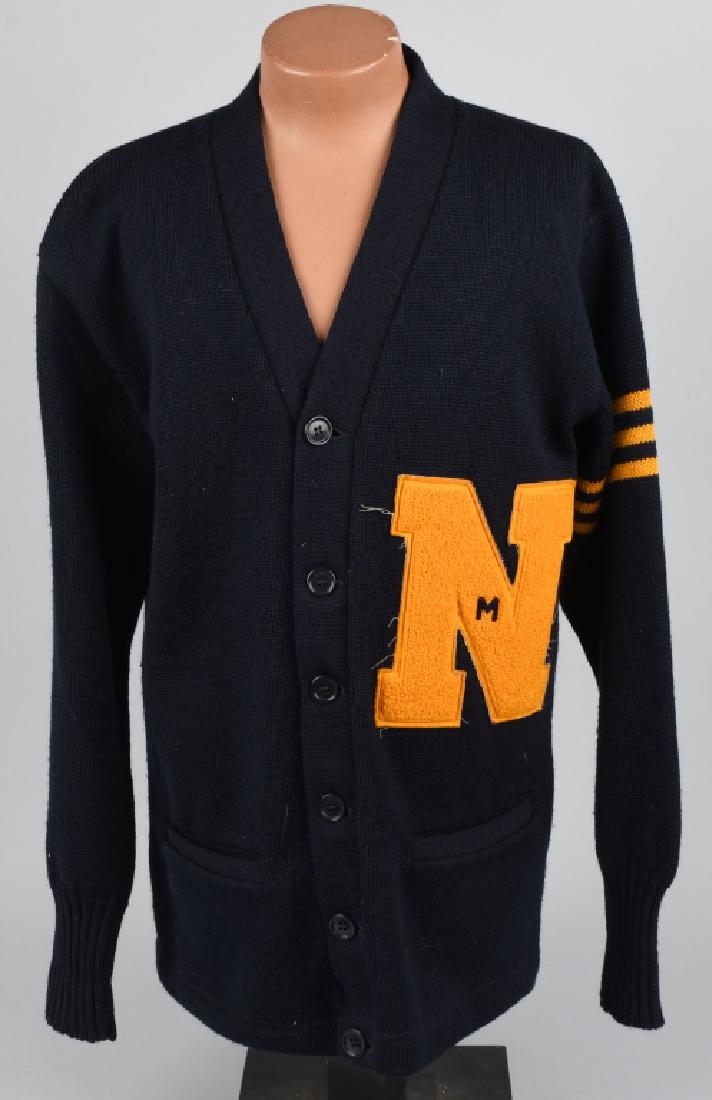 WWII US NAVAL ACADEMY ANNAPOLIS CADET SWEATER: Wool sweater with 7 buttons down the front and two lower pockets. Has three yellow bands around the left sleeve indicating a Junior class standing, and has machine-sewn "N" Naval Academy letterman's l