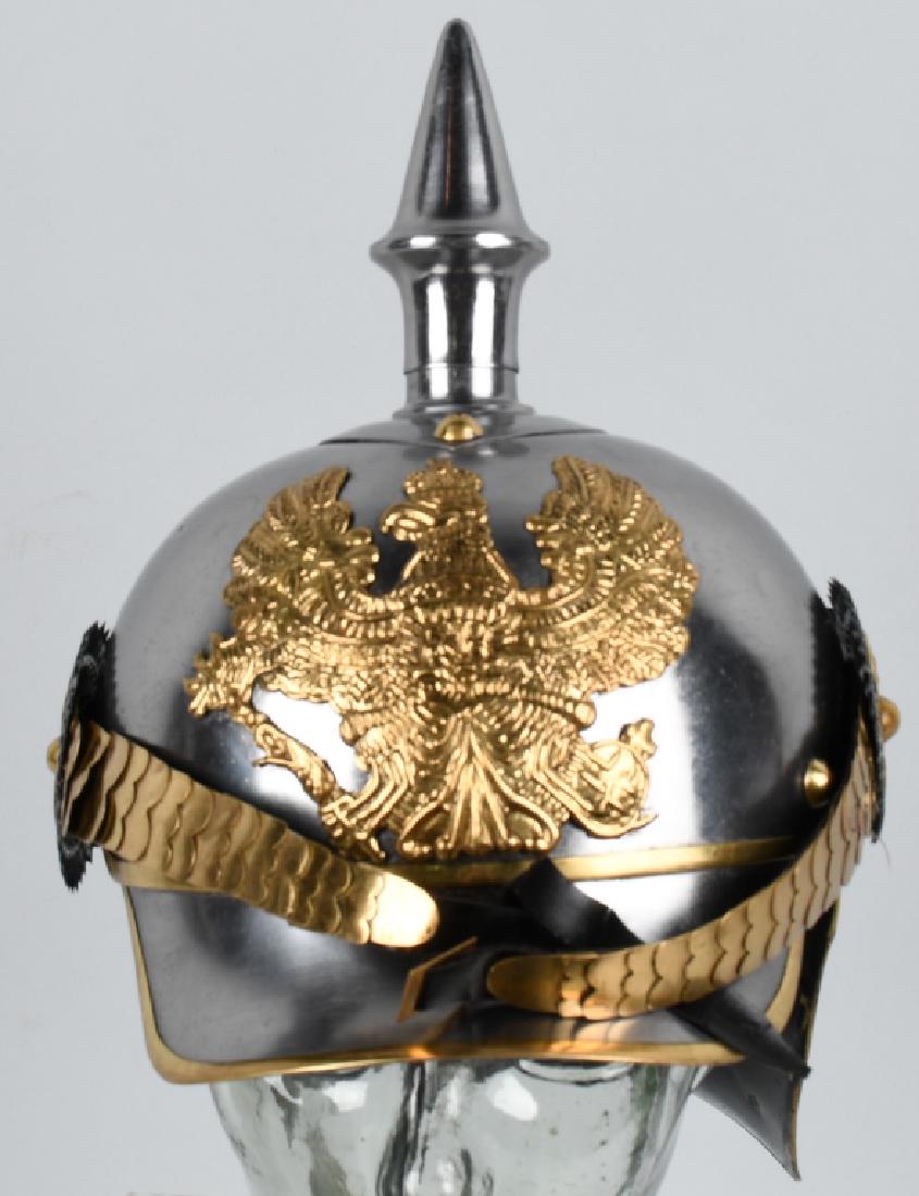 REPRODUCTION WWI GERMAN PICKELHAUBE: Reproduction of a WWI era German Lobster tail Pickelhaube spiked helmet. Features Prussian "FR" eagle crest, scaled brass chinstrap, leather suspension, and detachable spike. Brass rivets. Leather has