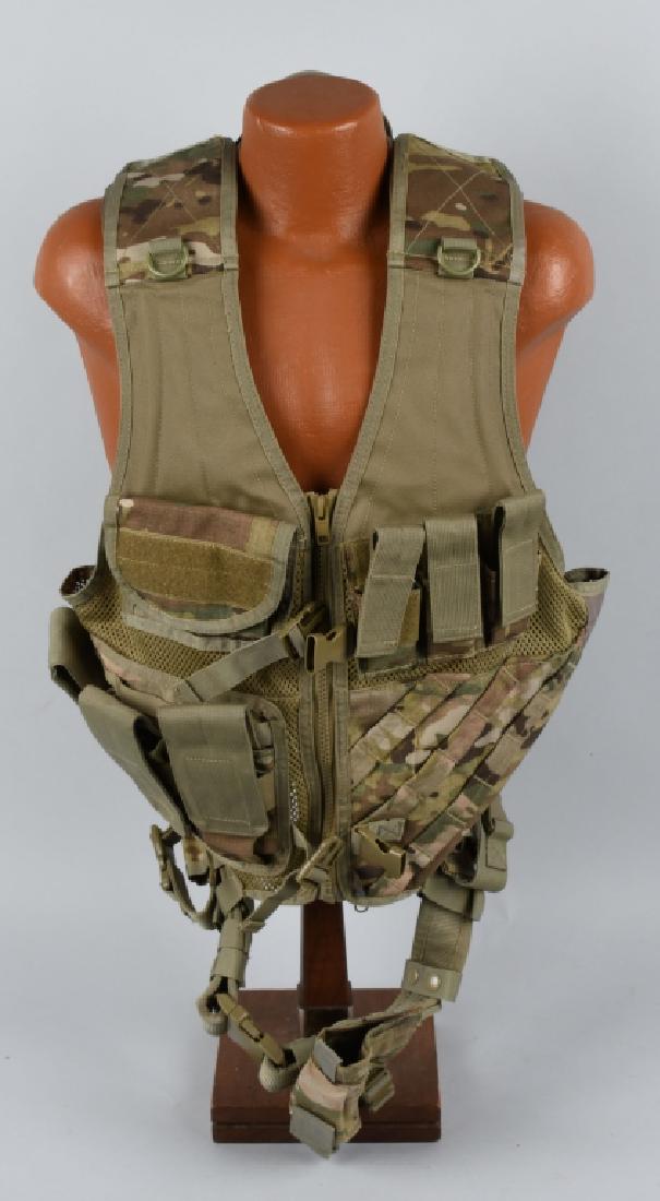 MULTICAM LOAD BEARING ASSAULT VEST WITH HOLSTER: Multicam pattern mesh assault vest with integral magazine pouches on the chest, breathable nylon mesh back and chest, heavy duty belt and buckle, and reinforced, rubberized shoulder pads on both sides