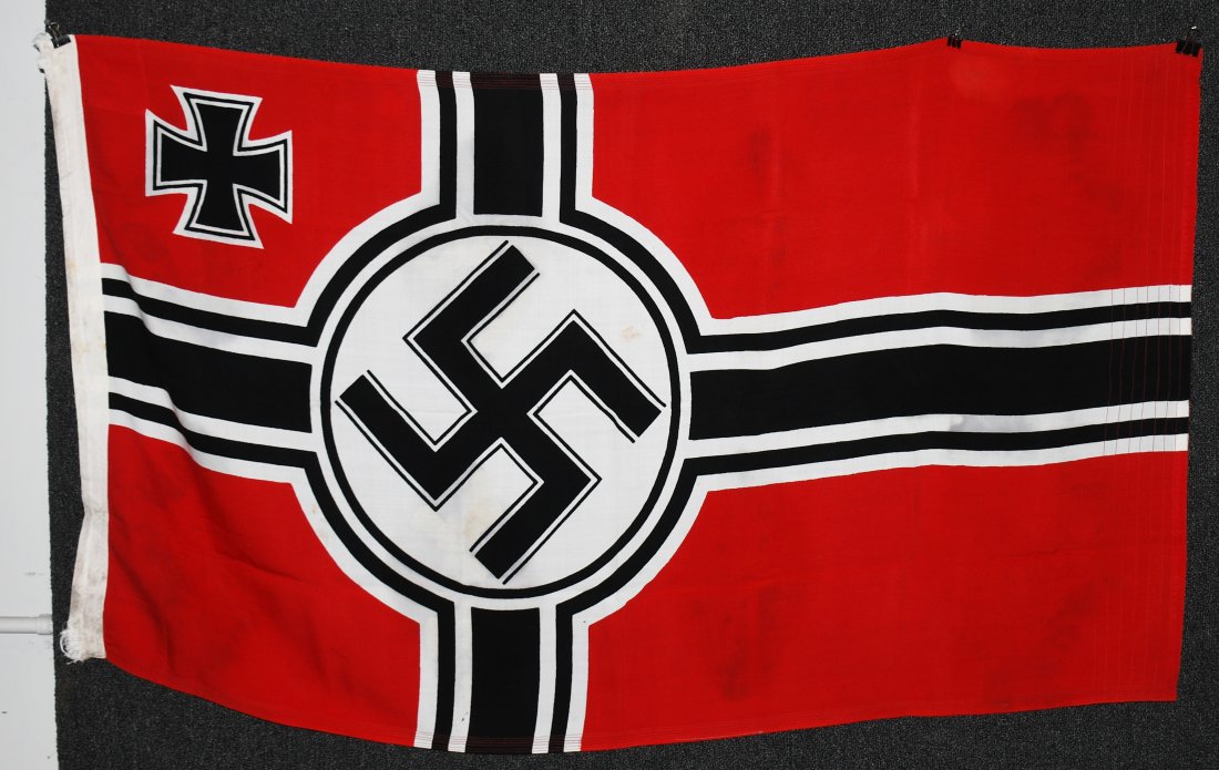 WWII NAZI GERMAN KRIEGSMARINE FLAG: Second pattern (Circa 1937/38-1945) single piece dual sided printed cotton/linen construction national war flag. The flag features a red base field with a central white/black/white/black bordered whit