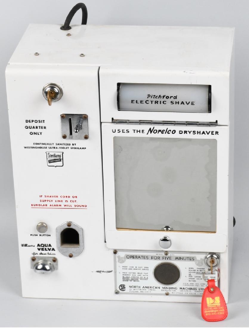 NORELCO COIN-OP ELECTRIC SHAVER: Pitchford Coin-Operated Electric Shaver. The Pitchford electric shave uses the Norelco Dryshaver; manufactured by Mountainaire Inc. of Springfield, MA, c.1940's. Features Williams Aqua Velva after sha