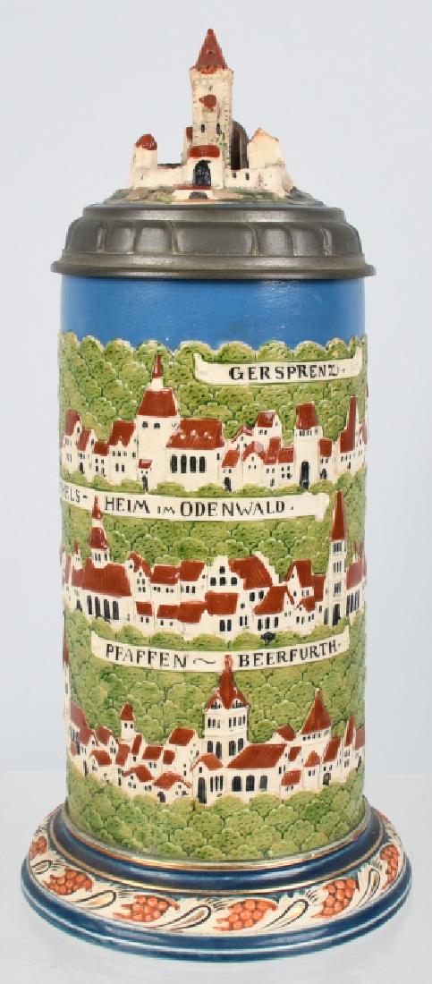 METTLACH #2829 RODENSTEIN CASTLE BEER STEIN: Wonderful Mettlach stoneware with village scenes throughout the stein. Has figural Castle for the lid. Very ornate stein. Has Mettlach markings on the bottom. All original with great colors. 11 1/2" E