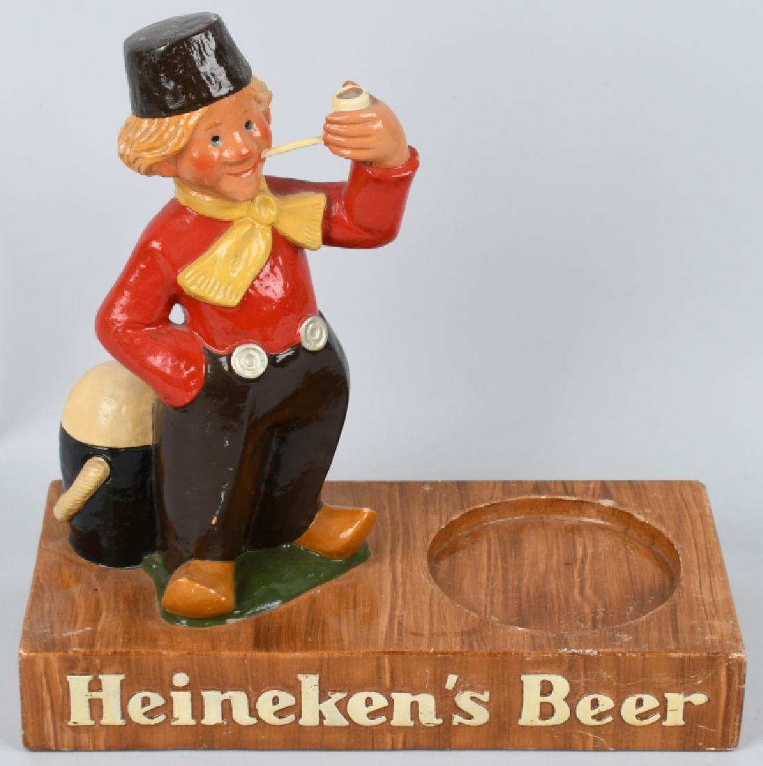 HEINEKEN's CERAMIC BEER STORE DISPLAY: Beautiful original ceramic Heineken's Beer store display. Has Dutch man standing and a place for a large bottle. 14 1/2" tall and 14" wide. Brewed in Holland. Light wear. Excellent