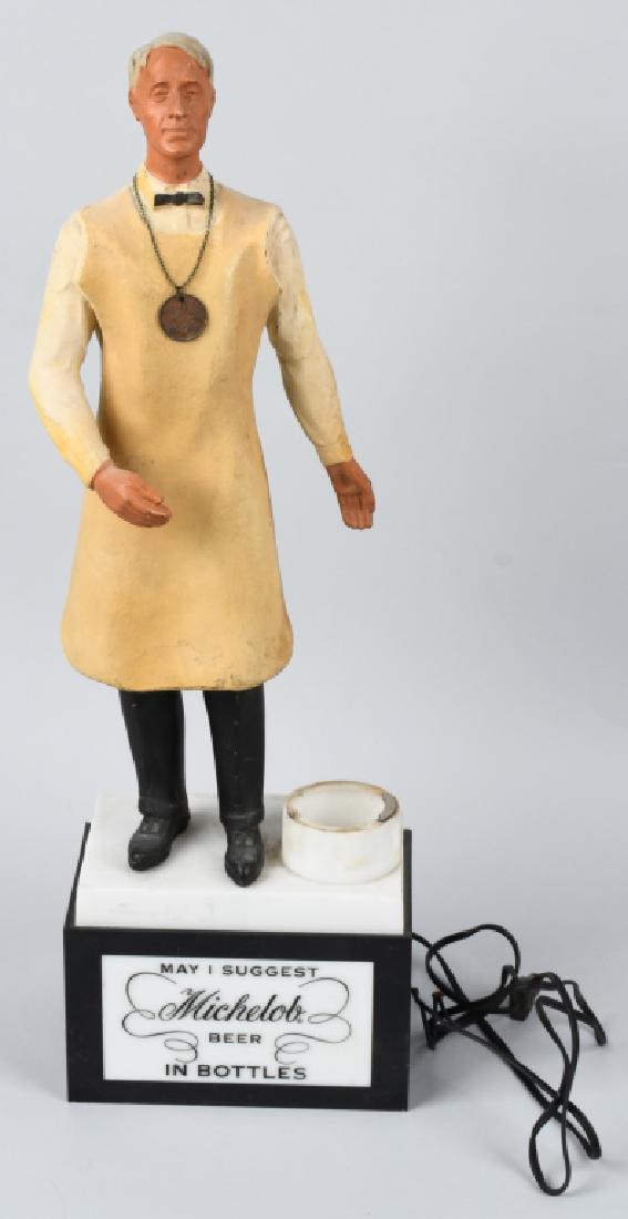 MICHELOB LIGHT UP STORE DISPLAY: Measures 24" to of brewer. He wears an apron and has a Anhueser-Busch medallion. Missing the light bulb and bottle. An unusual counter display. Man is loose from base. Brewed in St. Louis Missouri. Ve