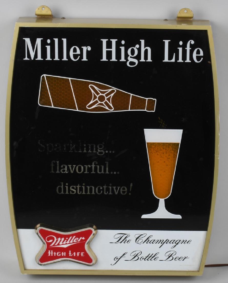 MILLER HIGH LIFE LIGHTED MOTION SIGN: Nice original sign that worked when tested. It appears that the bottle is actually filling the glass. Measures about 16" by 21" Brewed in Milwaukee, Wisconsin. Very Good-Excellent