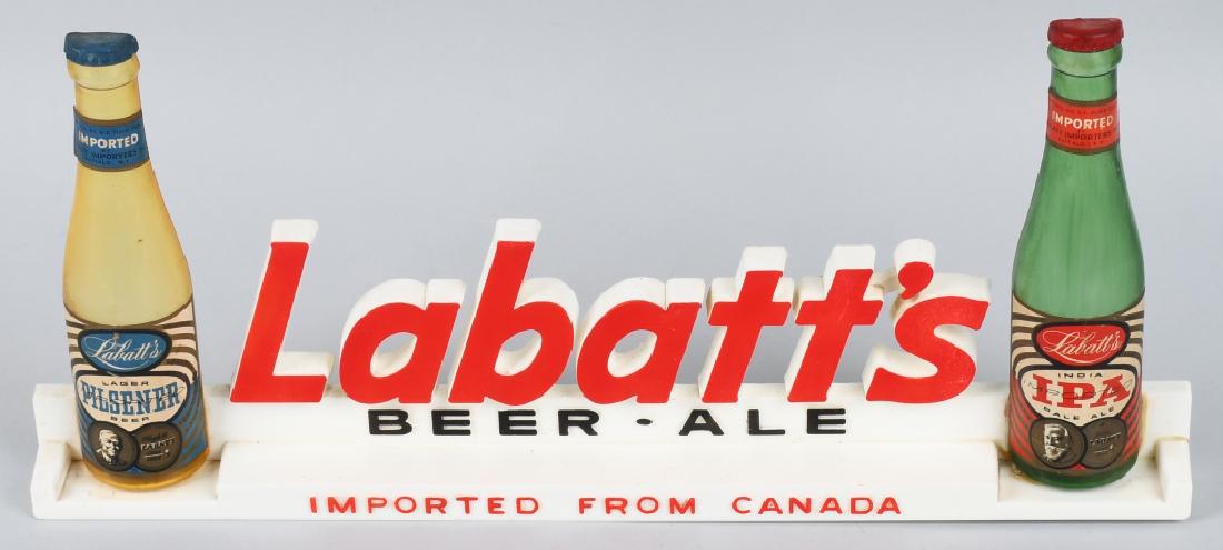 LABATTS BEER SHELF SIGN: Labatts Beer and Ale plastic Shelf Sign. Has two plastic bottles. 18 1/2" Excellent