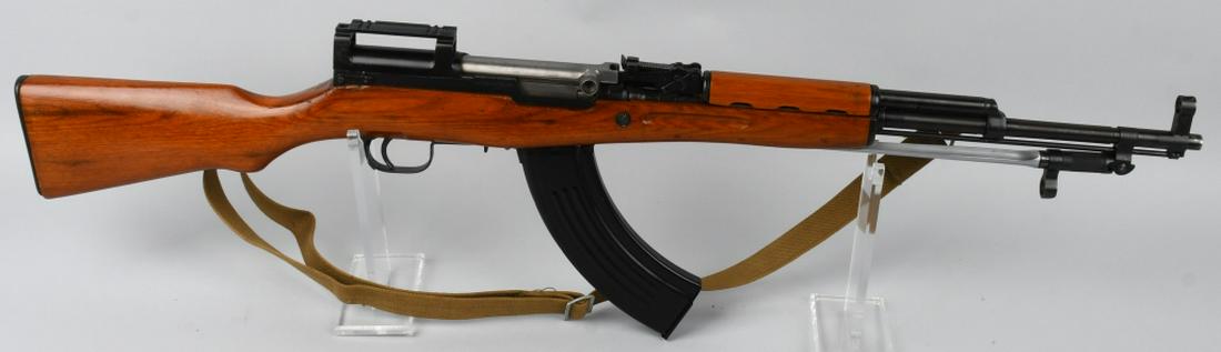 CHINESE NORINCO SKS 7.62 x 39 SEMI AUTOMATIC RIFLE: SN 230000699. 20" barrel semi automatic rifle in 7.62x39. Chinese SKS. Features adjustable rear sight, laminated wood stocks, original cleaning rod under the barrel, Chinese spike bayonet attached und