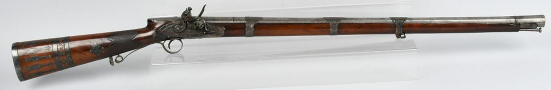 GEORGE III PARKER SILVER MOUNTED FLINTLOCK RIFLE: Very ornate early 19th century George III era silver mounted presentation flintlock musket with the lock maker marked W. Parker. Parker was a gun maker to his majesty George III. The rifled octagonal 