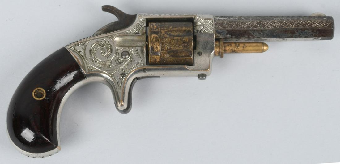 WHITNEYVILLE MODEL 1 ENGRAVED .22 REVOLVER: SN 12186, MFG 1871-1879, 2 3/4" .22 caliber octagon barrel. Marked "Whitneyville Armoury Ct. USA, Pat. May 23, 1871". The revolver is factory engraved and has gold wash cylinder and cylinder pin. Reta