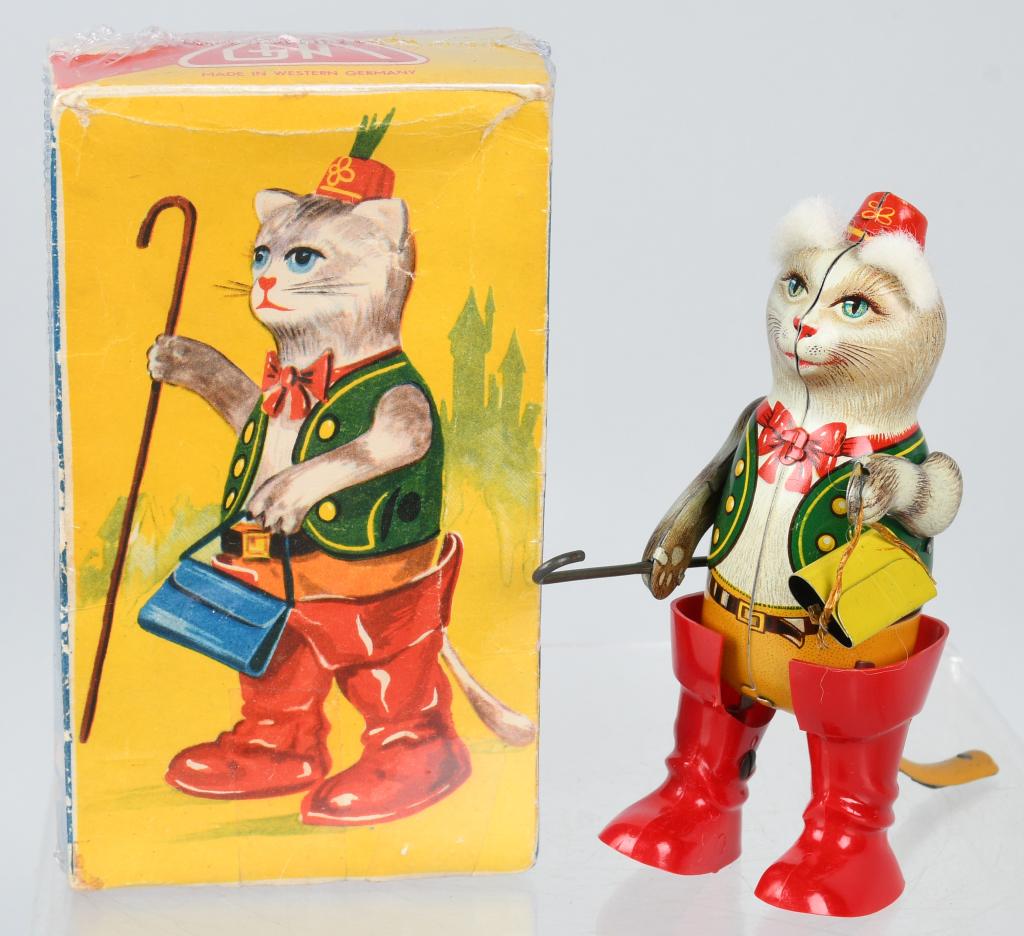 GNK Tin Windup PUSS IN BOOTS w/ BOX: Made in Western Germany. All original and complete with tin bag. Looks never played with condition. Windup works. With box. 6" Excellent-Near Mint