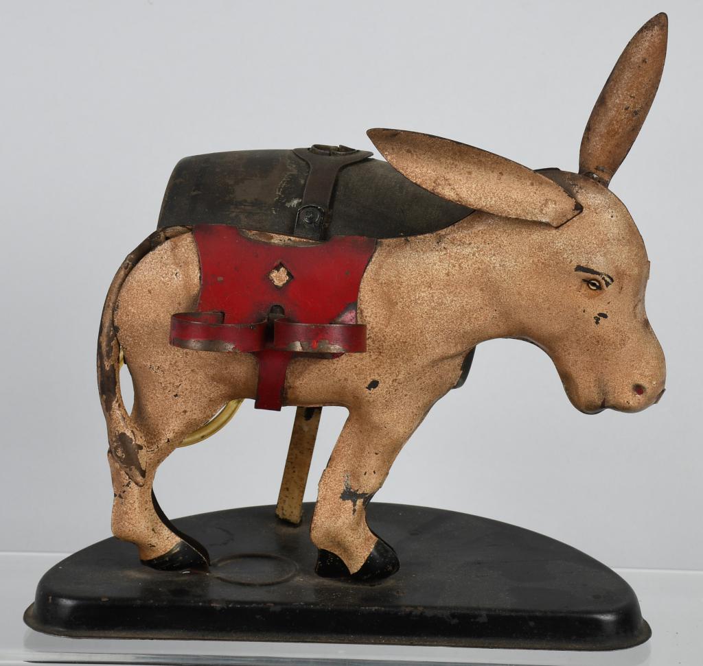 TIN MECHANICAL DONKEY SHOT DISPENSOR: All tin Donkey with cask on back. Pull Donkey's ear and tail raises and shot will pour from under the Donkey. All oriaginal.9" Excellent