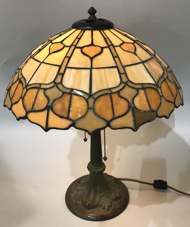 DUFFNER STAINED LEADED GLASS TABLE LAMP: Stained Leaded Glass Table Lamp. Nice shade with caramel colors. 16 1/2" wide by 6" high. Vent cover with heart cut outs. Nice ornate bronze base. Double socket with acorn pulls. No marking but has al
