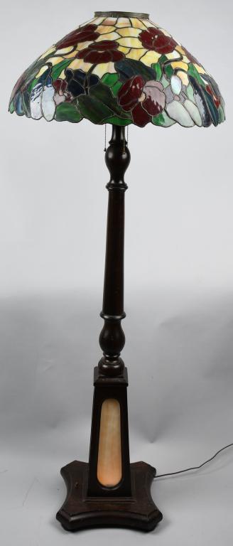 STAINED LEADED GLASS FLOOR LAMP: Stained Leaded Glass Floor Lamp. Stained leaded glass shade with floral pattern. Very colorful. 24" wide by 11" high. Wood base with slag glass inserts. Nice original finish. Missing the finial. 65" E