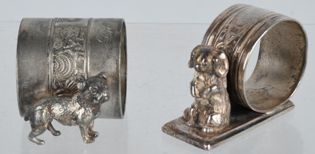 2-FIGURAL NAPKIN RINGS with DOGS: Nice figural dog napkin holders. Both are silverplate and well detailed. Largest is about 2 3/4". Excellent