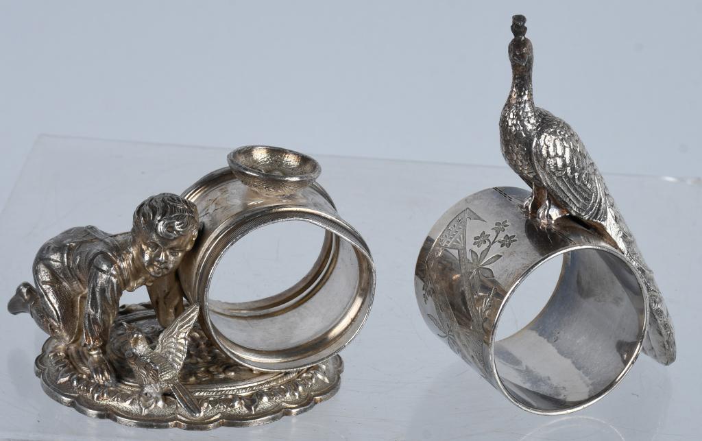 2-FIGURAL SILVERPLATE NAPKIN RINGS: Lot includes Boy, Bird and Birds nest. Very ornate and looks like to chip to wing. Makers mark is not clear. Also included is a Pheasant ring marked Meriden silver plate. Largest is 4", Excellent