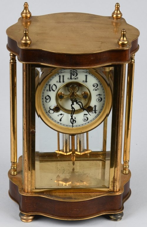 WATERBURY BRASS & GLASS MANTLE CLOCK: Nice original clock with brass and walnut case. The clock has beveled glass throughout and a porcelain face. Works are marked Waterbury Clock Co. USA. 11" by 7" by 5". Very Good-Excellent