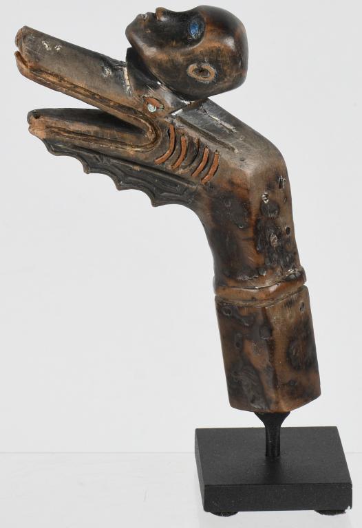 TIMOR ISLAND SWORD HANDLE ca. 19th C.: Timor Island 19th Century Dragon Mouth Wood Handle with Trophy Head 2 blue Stones as Inlayed Eyes. Provenance: Ex- private collection of Ami Brown. Mr. Brown was the owner of the Coca Cola franchise i