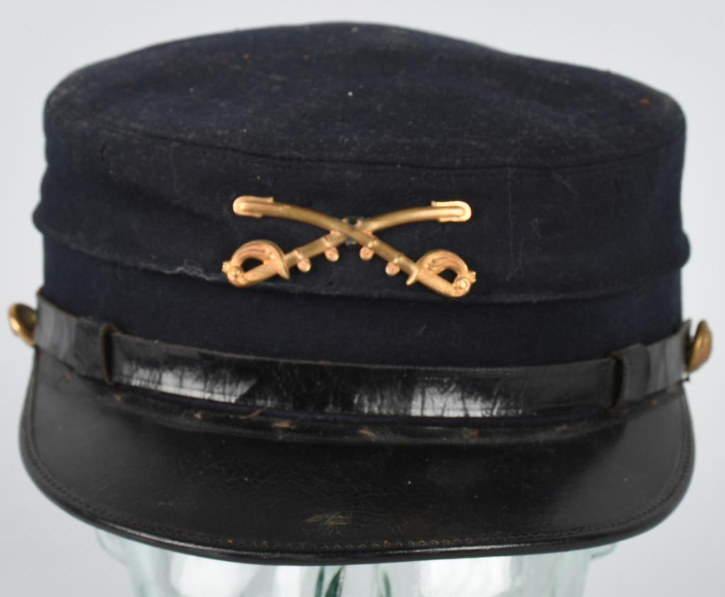 U.S. MODEL 1895 CAVALRY ENLISTEDMAN's CAP: Cap was made by the famous W.H. Horstmann Company Philadelphia. Cap is complete and has the correct crossed sword device and eagle buttons. Has some light soiling and some moth nips. Includes oil clot