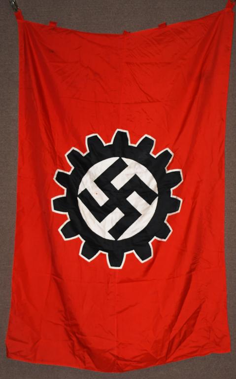 WWII NAZI GERMAN SILK DAF UNIT FLAG: A 51 x 76 inches and is double-sided multi-piece silk construction factory unit flag. The flag features a red base field upon which is sewn a white bordered, black DAF fourteen cog wheel encompassing 