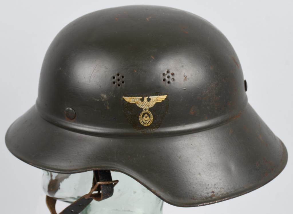 WWII RAD DOUBLE DECAL BEADED M38 GLADIATOR HELMET: One piece stamped sheet steel construction M38 "Gladiator" style helmet retains a good of its overpainted smooth brown painted finish. The helmet has a RAD decal to each side of the helmet. The helmet