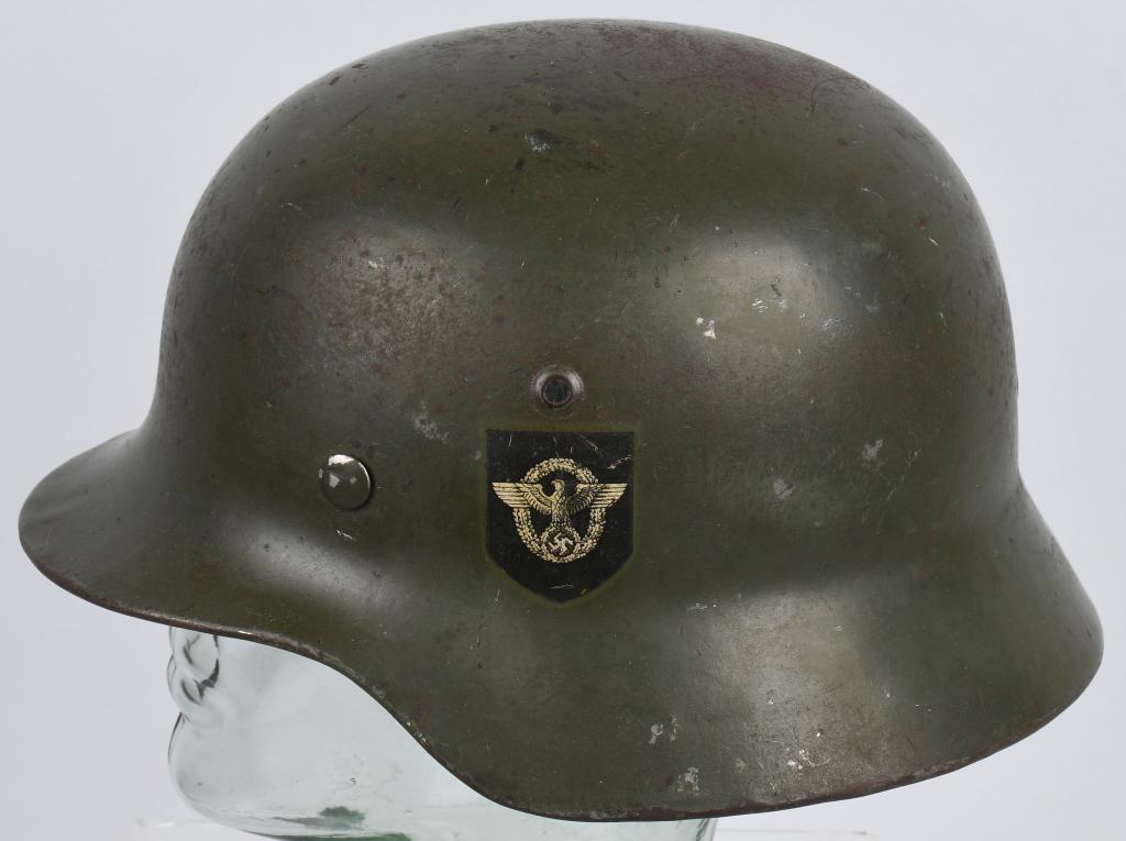 WWII NAZI GERMAN M35 DOUBLE DECAL POLIZEI HELMET: Helmet retains most of it’s original smooth field-grey paint. Second pattern un-bordered Police eagle decal and pointed tip party shield decal are both retained about 95%. All three liner retaining 