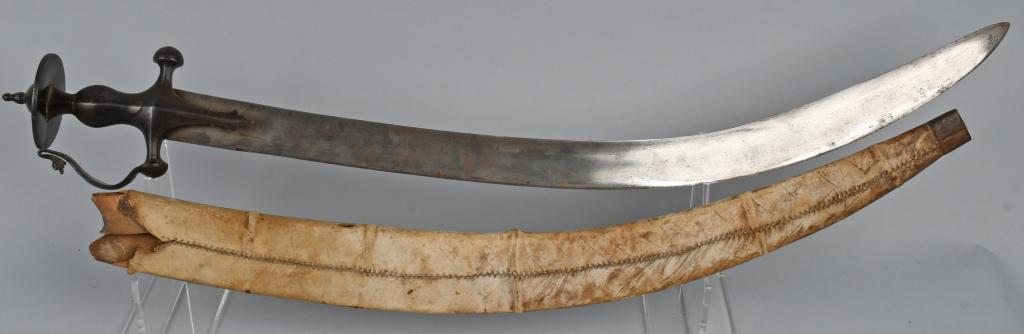 INDIAN TULWAR SWORD WITH D GUARD AND SCABBARD: Indian Tulwar with D guard handle and original leather covered wooden scabbard with steel tip. Blade has a deep curve with wide fuller. Steel hilt fits nice and firm to the blade with no looseness. Hi