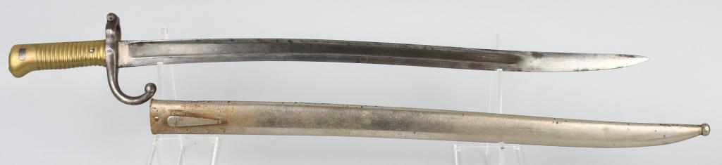 FRENCH MODEL 1866 CHASSEPOT SABER BAYONET: French Model 1866 Chassepot saber bayonet and scabbard. 22 1/2" yataghan fullered blade that is 1 1/8" wide. Ricasso has an indiscernible makers mark. ". Blade has a scattered areas of light pitting, 