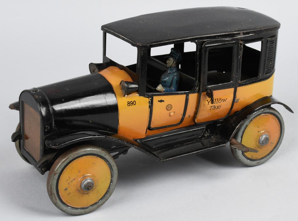 GUNTHERMANN Tin Windup YELLOW TAXI: Excellent tin windup Yellow Taxi made in Germany. All original and complete. Has opening doors and driver/ Windup works. Nice German Car. 9" Excellent