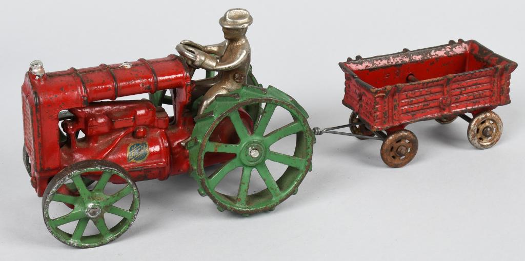 ARCADE CAST IRON FORDSON TRACTOR & WAGON: Original cast iron Fordson Tractor and Wagon. Both with original paint. Tractor is red with green wheel version. Has nice Arcade stick. Still has original driver. Wagon has more wear. No breaks or iss