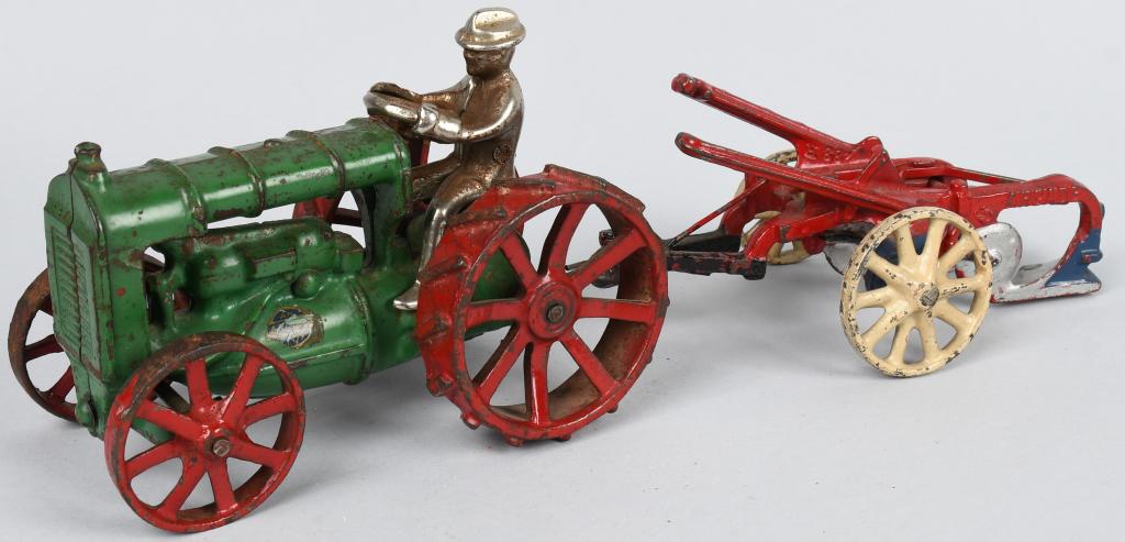 ARCADE CAST IRON FORDSON TRACTOR & PLOW: Original cast iron Fordson Tractor and Plow. Both with original paint. Tractor is red with green wheel version. Has nice Arcade stick. Still has original driver. No breaks or issues. 12" Very Good